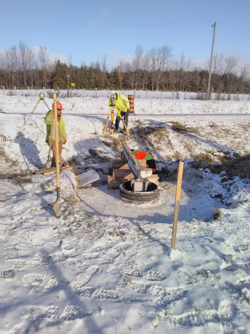 Workers installing a gutter in winter